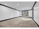 Spacious room with a window and modern black trim, perfect for entertaining and Gathering gatherings at 5204 Heron Bay Blvd, Locust Grove, GA 30248