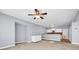 Open concept living room with a partial kitchen, ceiling fan, and grey walls at 5204 Heron Bay Blvd, Locust Grove, GA 30248