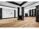 Large living room with hardwood floors and black trim accents at 5204 Heron Bay Blvd, Locust Grove, GA 30248
