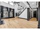 Open living room featuring hardwood floors, a fireplace, a ceiling fan, and tall windows at 5204 Heron Bay Blvd, Locust Grove, GA 30248
