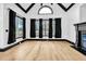 Inviting living room with large windows, a fireplace, hardwood flooring, and high ceilings at 5204 Heron Bay Blvd, Locust Grove, GA 30248
