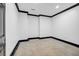 Room featuring white walls, concrete floors, black trim, and recessed lighting at 5204 Heron Bay Blvd, Locust Grove, GA 30248