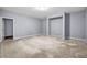 Room featuring grey walls, tile floors, a closet and white trim at 5204 Heron Bay Blvd, Locust Grove, GA 30248