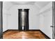 Cozy walk-in closet with overhead shelving, window, and hardwood flooring for optimal storage solutions at 5204 Heron Bay Blvd, Locust Grove, GA 30248
