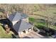 Aerial view showing a home with a rear deck, attached garage, and well-manicured landscaping at 5254 Franklin Goldmine Rd, Cumming, GA 30028