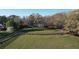 Beautiful property featuring a well-maintained lawn, fenced pasture, and an elegant brick home with a columned facade at 5254 Franklin Goldmine Rd, Cumming, GA 30028