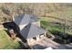 Aerial view showing the home's back with carports, deck, and yard backing up to wooded acreage at 5254 Franklin Goldmine Rd, Cumming, GA 30028