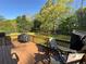 Outdoor living on a spacious wood deck with grill, seating, and a view of the lush backyard at 5254 Franklin Goldmine Rd, Cumming, GA 30028