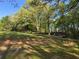 Expansive backyard featuring mature trees that shade the manicured lawn at 5254 Franklin Goldmine Rd, Cumming, GA 30028