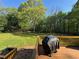 Back deck featuring a grill and a beautiful view of the expansive backyard at 5254 Franklin Goldmine Rd, Cumming, GA 30028