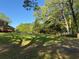 Spacious backyard features mature trees offering shade and a well-maintained lawn at 5254 Franklin Goldmine Rd, Cumming, GA 30028