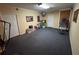 Spacious basement with gray carpet, storage bins, and an inversion table at 5254 Franklin Goldmine Rd, Cumming, GA 30028