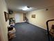 Finished basement with neutral carpet, pale yellow walls, and fluorescent ceiling lights at 5254 Franklin Goldmine Rd, Cumming, GA 30028