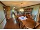 Dining room showcasing wooden floors and trim leading to a fully equipped kitchen at 5254 Franklin Goldmine Rd, Cumming, GA 30028