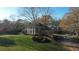 Aerial view of a traditional two-story brick home with white columns and a large, manicured front lawn at 5254 Franklin Goldmine Rd, Cumming, GA 30028