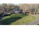 Elegant brick home with a classic columned front, sprawling lawn, and a circular driveway at 5254 Franklin Goldmine Rd, Cumming, GA 30028