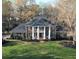 Stately brick home with columned porch and lush landscaping on expansive manicured lawn at 5254 Franklin Goldmine Rd, Cumming, GA 30028