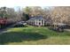 Impressive brick home with a large lawn, mature trees, and a classic columned front porch at 5254 Franklin Goldmine Rd, Cumming, GA 30028
