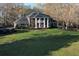 Gorgeous brick home with a grand columned entrance, lush lawn, and mature trees at 5254 Franklin Goldmine Rd, Cumming, GA 30028