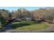 Inviting brick home with white columns, a sprawling lawn, and mature trees enhancing its curb appeal at 5254 Franklin Goldmine Rd, Cumming, GA 30028