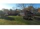 Aerial view showcases a home's manicured lawn, mature trees, and classic brick facade at 5254 Franklin Goldmine Rd, Cumming, GA 30028