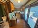 Well-lit kitchen boasts ample cabinetry, granite counters, hardwood floors and access to a deck with sliding glass doors at 5254 Franklin Goldmine Rd, Cumming, GA 30028