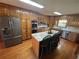 Well-equipped kitchen with stainless steel appliances, granite countertops, and center island at 5254 Franklin Goldmine Rd, Cumming, GA 30028