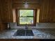 Bright kitchen featuring granite countertops, a mosaic tile backsplash, and a window overlooking the backyard at 5254 Franklin Goldmine Rd, Cumming, GA 30028