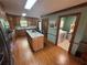 Oak kitchen overlooking a full laundry room featuring granite countertops and tile backsplash at 5254 Franklin Goldmine Rd, Cumming, GA 30028