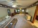 Large living room featuring carpet, ceiling fans, and natural light at 5254 Franklin Goldmine Rd, Cumming, GA 30028