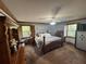 Comfortable main bedroom with dual windows, neutral walls, carpet flooring, and dark wood trim at 5254 Franklin Goldmine Rd, Cumming, GA 30028