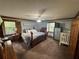 Spacious main bedroom with dual windows, neutral walls, carpet flooring, and dark wood trim at 5254 Franklin Goldmine Rd, Cumming, GA 30028