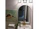 Bright bathroom vanity with a unique rounded mirror and a charming robin painting for added character at 5728 Norman Ct, Atlanta, GA 30349