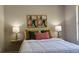 Comfortable bedroom featuring two side tables, lamps, and colorful throw pillows at 5728 Norman Ct, Atlanta, GA 30349