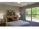 Cozy bedroom with natural light, neutral walls, and comfortable bedding at 5728 Norman Ct, Atlanta, GA 30349