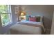 Charming bedroom with a comfortable bed, side table, and natural light from the window at 5728 Norman Ct, Atlanta, GA 30349