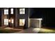 Home exterior shot at night, lights on at 5728 Norman Ct, Atlanta, GA 30349