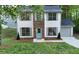Charming two-story home with a brick facade, light blue door, light gray shutters and a well-maintained front yard at 5728 Norman Ct, Atlanta, GA 30349