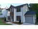 Two-story home with a light blue door, brick accent, light gray shutters, and a gray garage door at 5728 Norman Ct, Atlanta, GA 30349