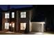 Home exterior shot at night, lights on at 5728 Norman Ct, Atlanta, GA 30349