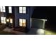 A two-story home with lights on the front door and over the garage at 5728 Norman Ct, Atlanta, GA 30349