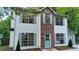 Charming two-story home with a brick accent, large windows, and a welcoming blue door at 5728 Norman Ct, Atlanta, GA 30349