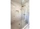 Modern shower with a glass enclosure, stylish tile, and a rainfall showerhead, creating a spa-like experience at 5728 Norman Ct, Atlanta, GA 30349