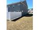 Backyard featuring a white privacy fence with grass and gray siding in the background at 860 Point Place Dr, Loganville, GA 30052