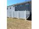 Backyard featuring a white privacy fence with grass and gray siding in the background at 860 Point Place Dr, Loganville, GA 30052