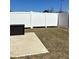 Backyard featuring a small patio and a brown storage box behind a white privacy fence at 860 Point Place Dr, Loganville, GA 30052