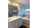 Bathroom featuring a tub, separate glass shower, dual sinks, and wood-look floors at 860 Point Place Dr, Loganville, GA 30052