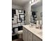 A modern bathroom featuring a dual sink vanity with a neutral color scheme and geometric-patterned shower curtain at 860 Point Place Dr, Loganville, GA 30052
