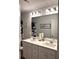Bright bathroom features a double sink vanity, modern lighting, and a framed mirror for an added touch of elegance at 860 Point Place Dr, Loganville, GA 30052