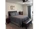 A cozy bedroom boasts a plush bed, dresser, and ceiling fan, providing comfort and functionality at 860 Point Place Dr, Loganville, GA 30052